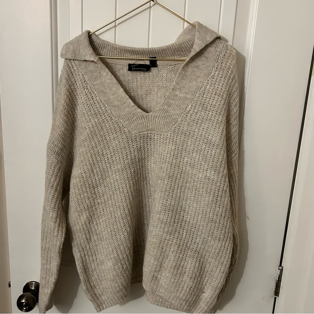 Woman’s beige V neck sweater